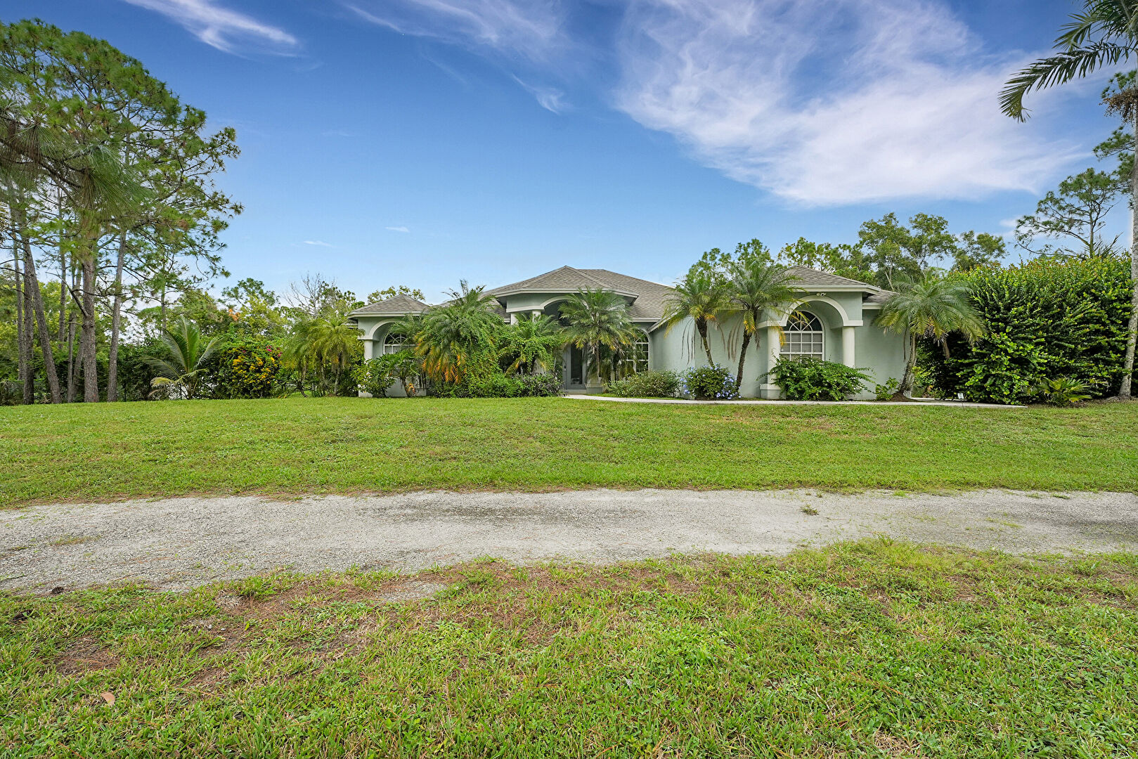 Front at 17673 75th Place North, The Acreage, FL 33470, listed by Ravi Mohanka