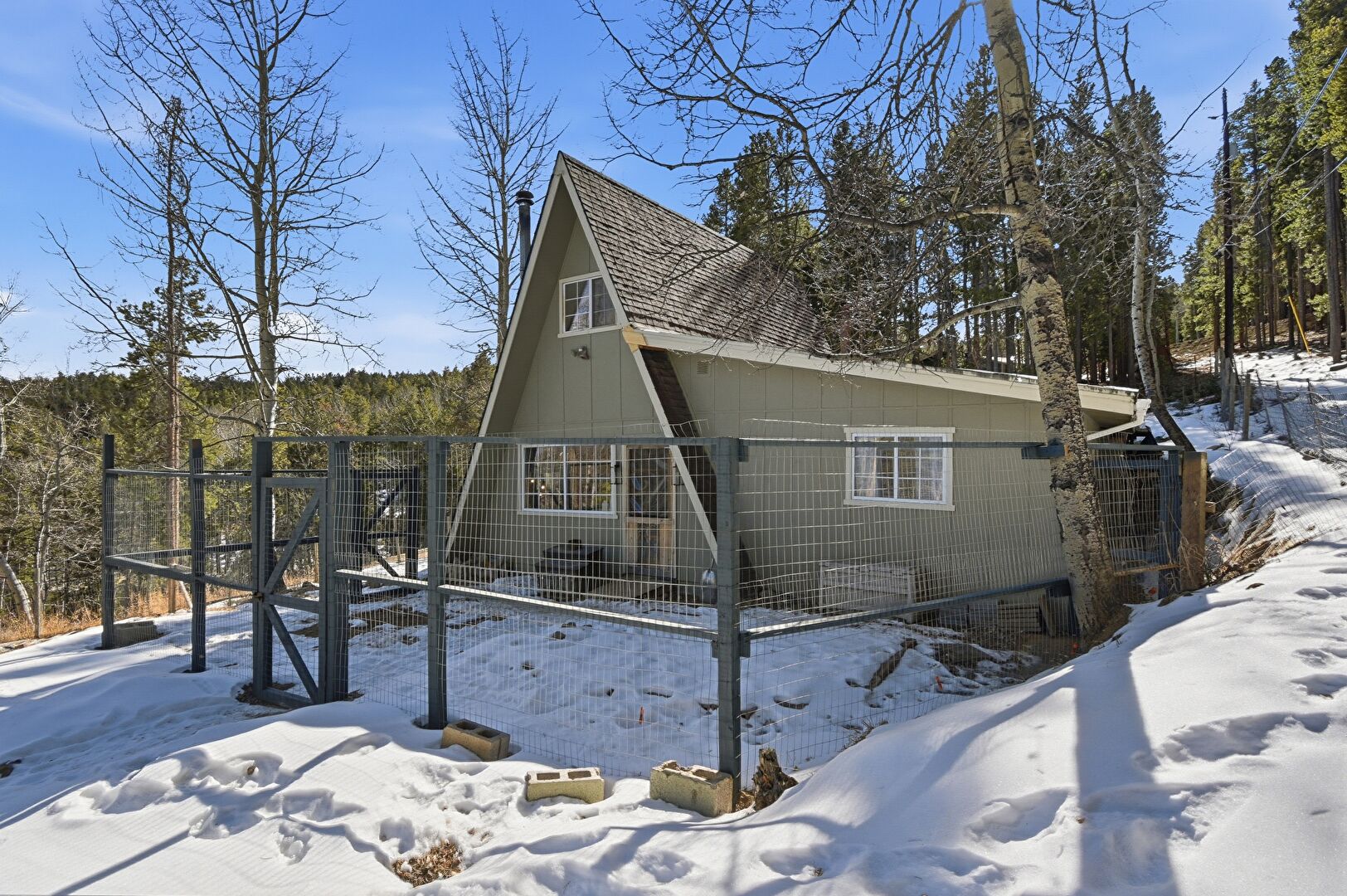 Front at 527 Apache Road, Evergreen, CO 80439, listed by Jenna and Patrick McMenaman