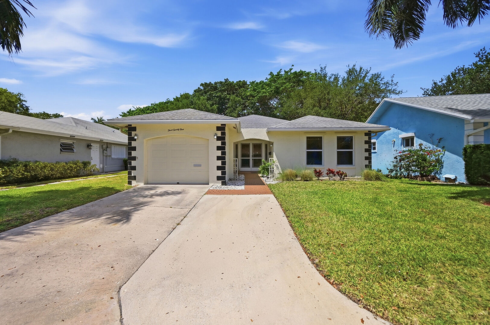 Front yard at 321 Del Rio Boulevard, Boca Raton, FL 33432, listed by Joanna Doldan
