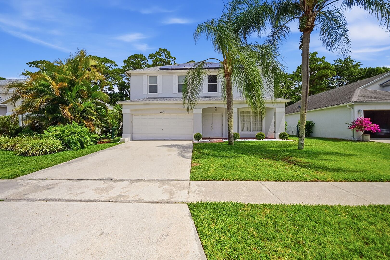 Front yard at 15073 Oak Chase Court, Wellington, FL 33414, listed by Armando Hassey