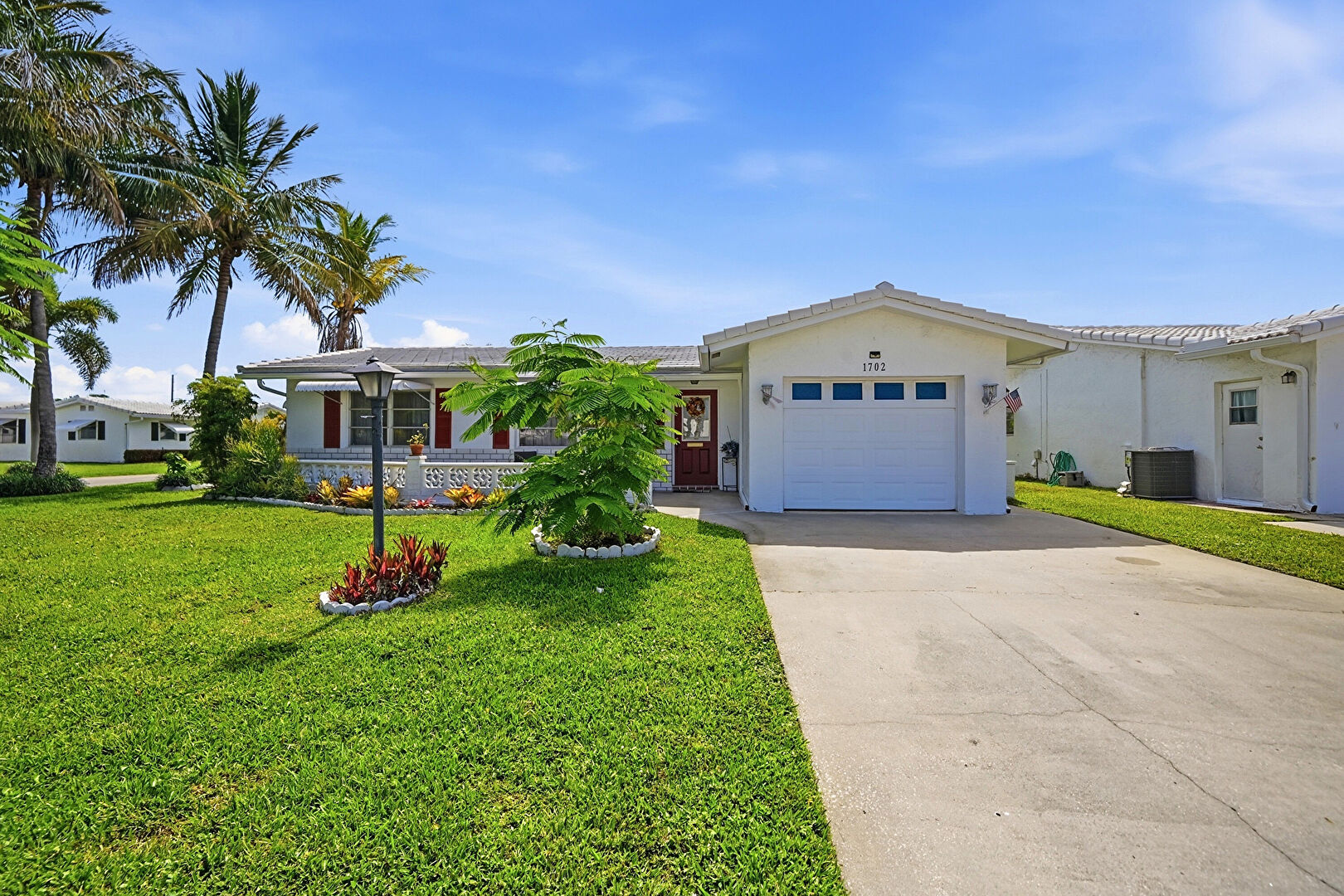Front yard at 1702 Southwest 22nd Street, Boynton Beach, FL 33426, listed by Aurea Suss