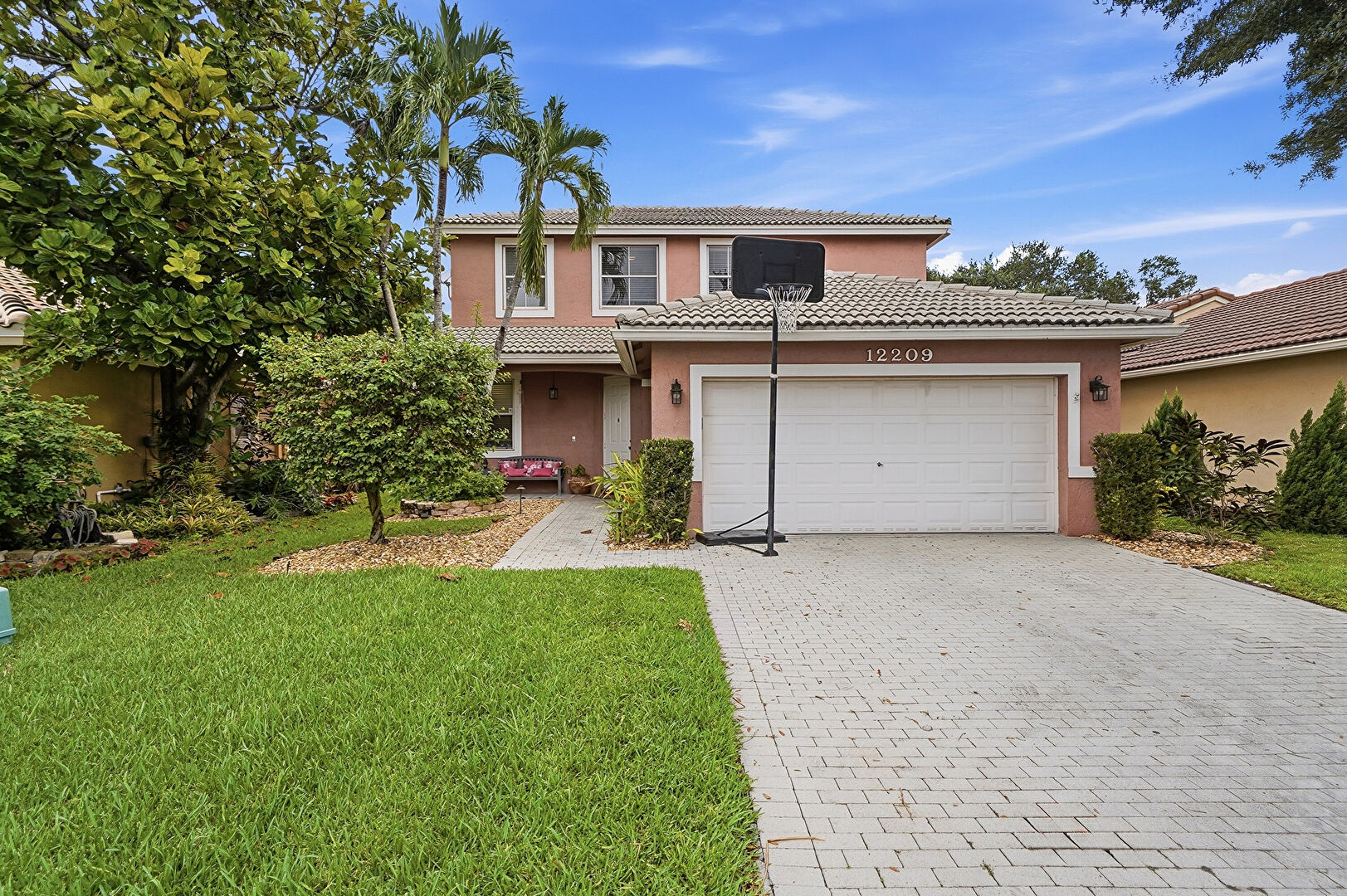 Front at 12209 NW 57th Street, Coral Springs, FL 33076, listed by Laura Sanders