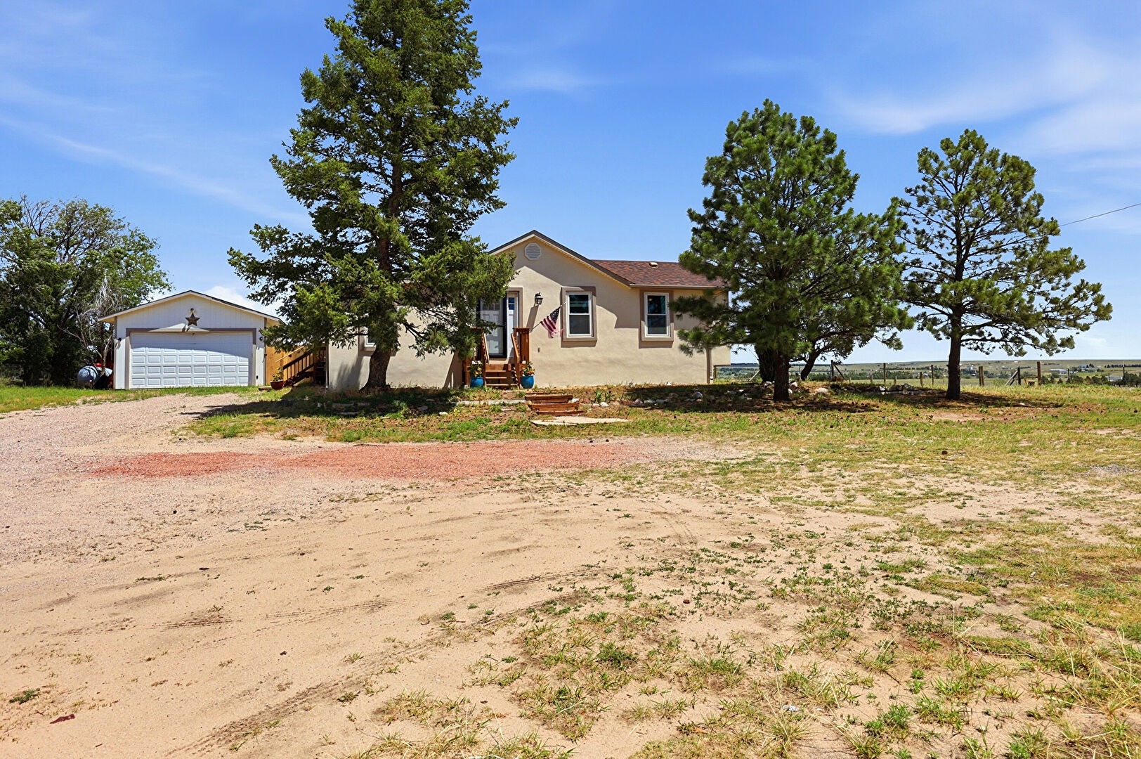Front at 18420 1st Street, Street sign is MANITOU ST., Peyton, CO 80831, listed by Lauren Christmas