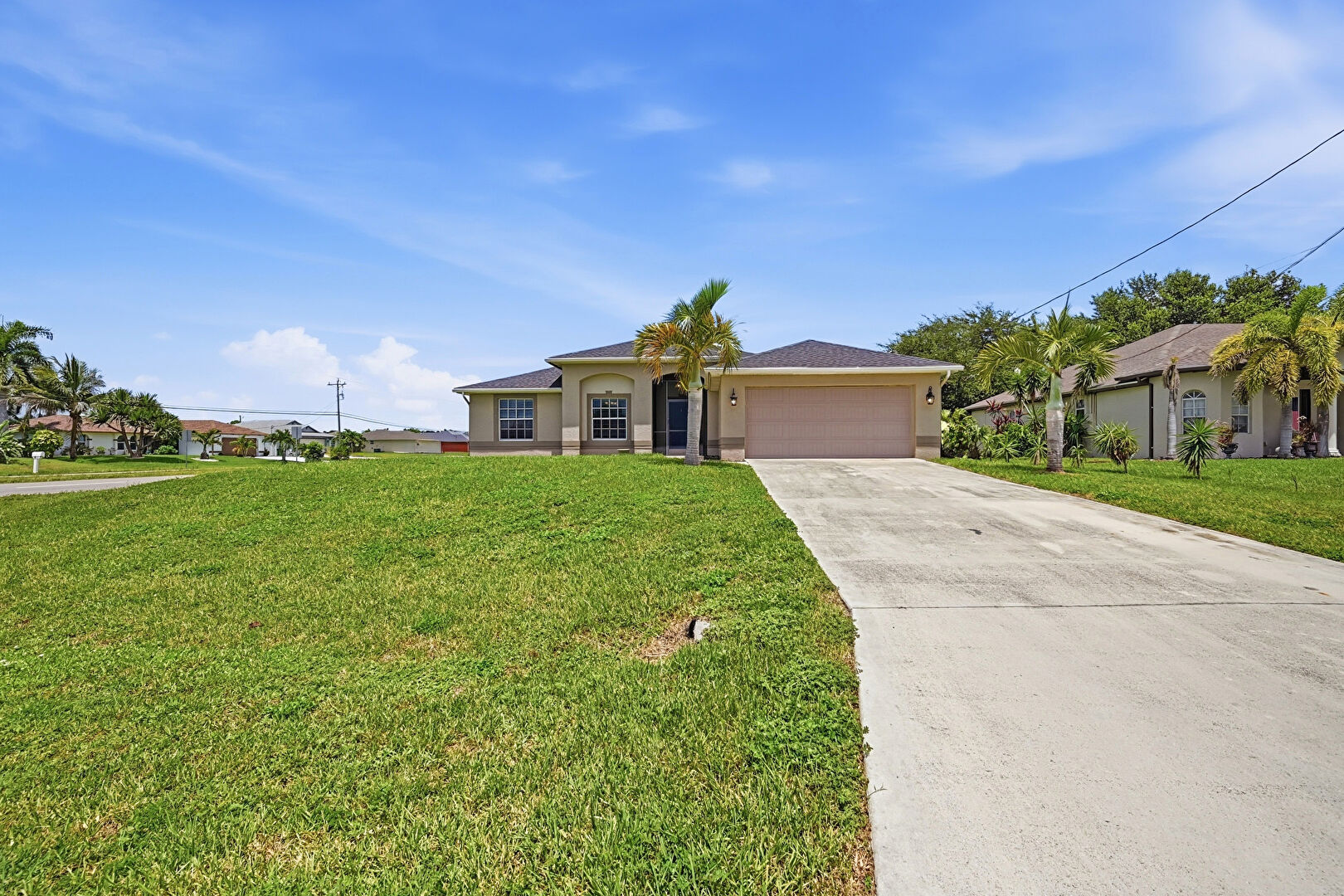 Front yard at 4155 Northeast 15th Place, Cape Coral, FL 33909, listed by Paola Giraldo