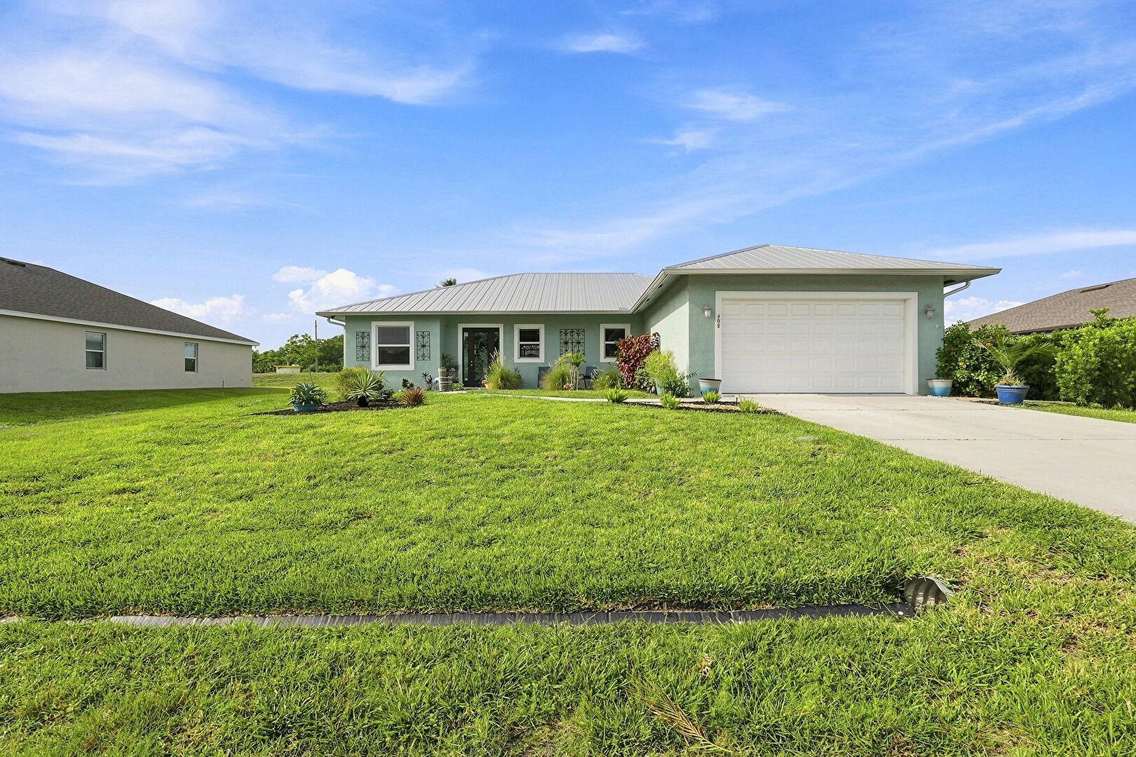Front at 408 SW Aster Rd, PORT ST LUCIE, FL 34953, listed by Manuel (Manny) Rey