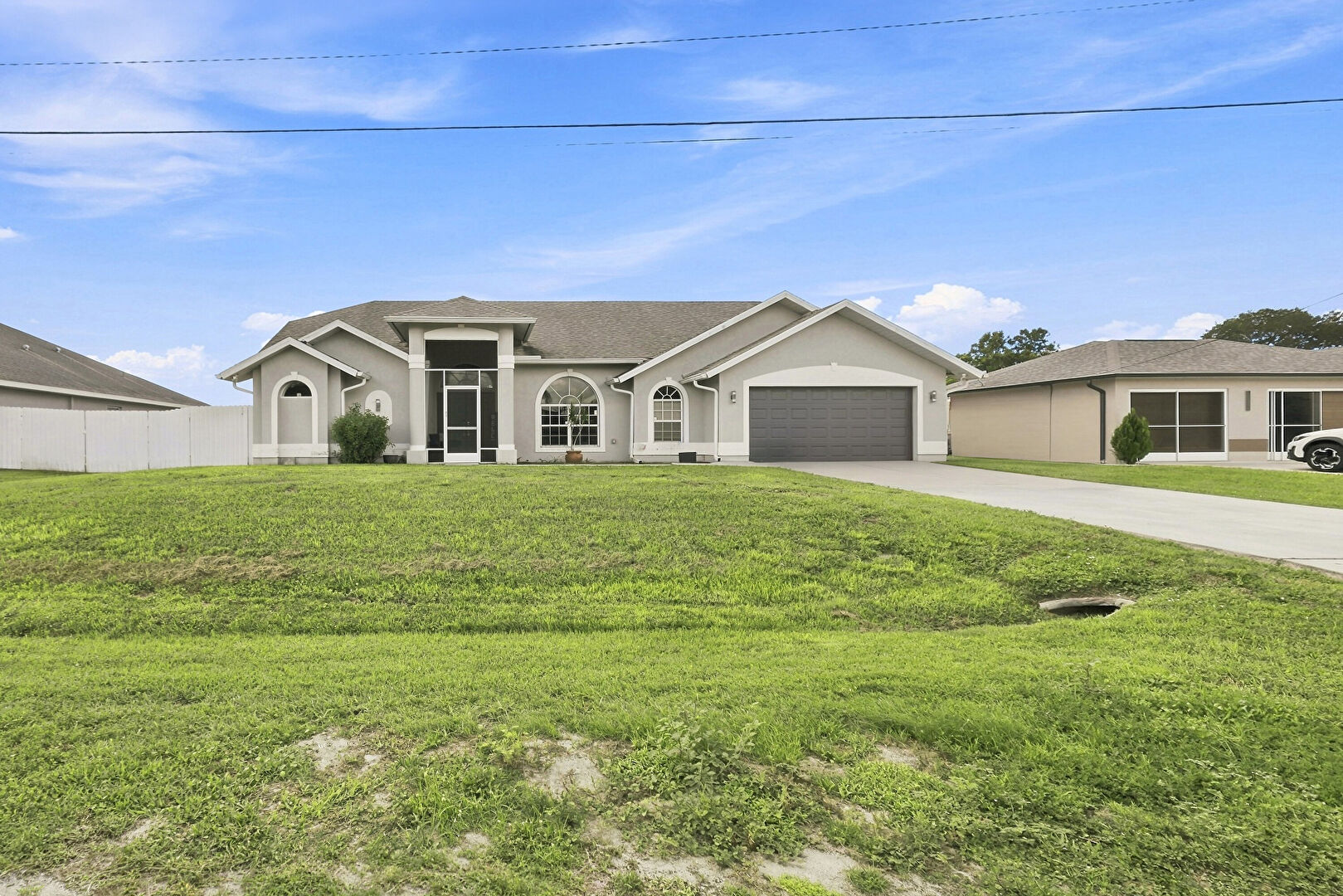 Front at 680 Manhattan Street East, Lehigh Acres, FL 33974, listed by Teresita Amado