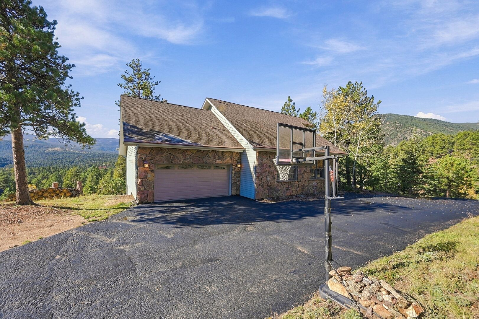 Front at 126 Columbine Lane, Evergreen, CO 80439, listed by Pandora & John Erlandson