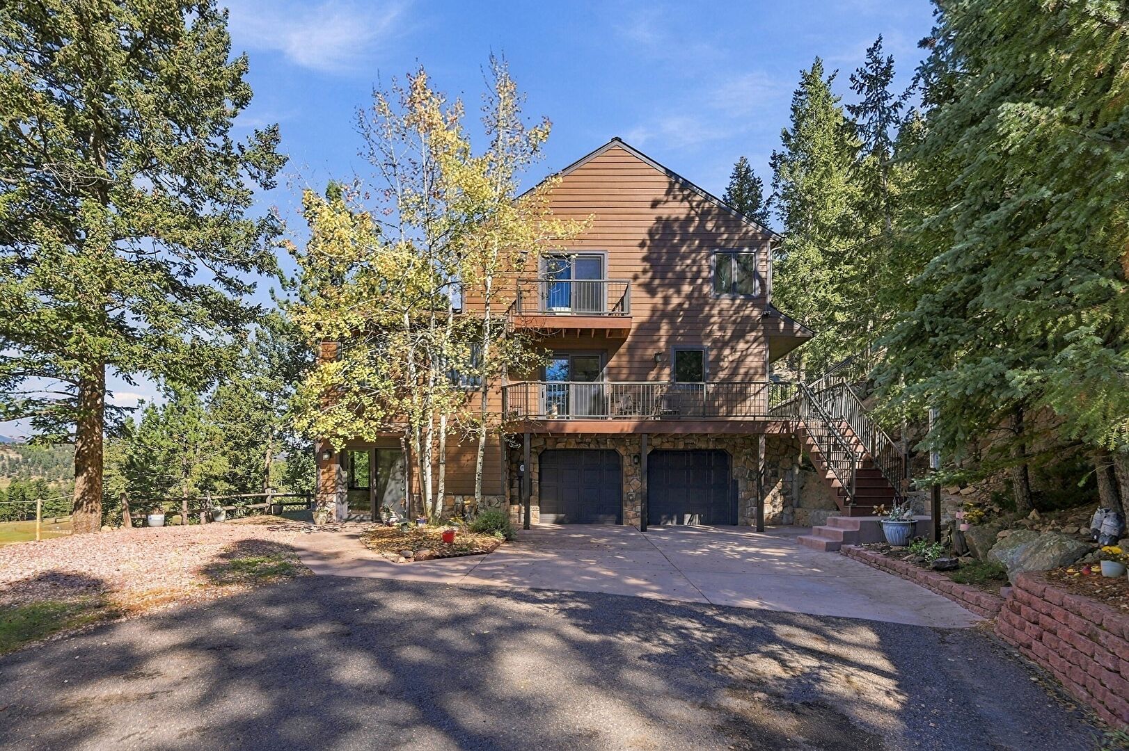 Front at 6220 South Bluebell Lane, Evergreen, CO 80439, listed by Pandora & John Erlandson